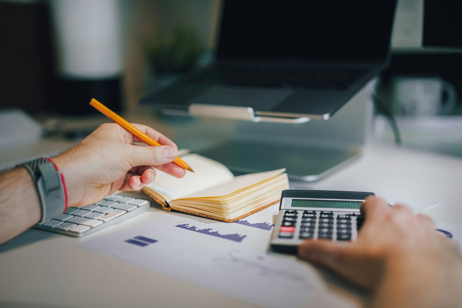Accountant working with calculator and financial notes